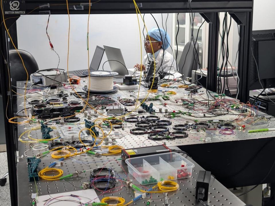 A Quanfluence engineer testing photonic hardware on an optical bench
